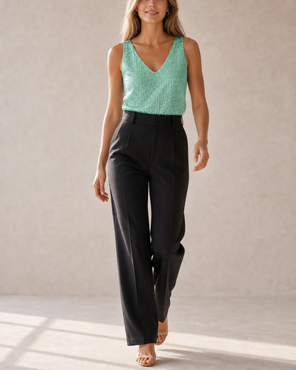 Women's green sequin V-neck tank top shown in a natural front movement pose — momount-martha-sequin-top-green-06-movement.webp