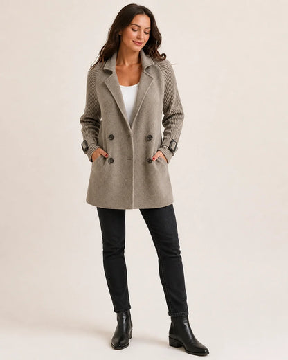 Taupe mid-length coat with knit sleeves, full silhouette.