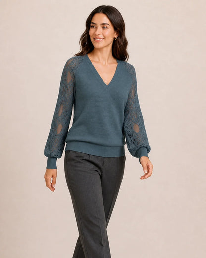Women's Storm Blue ribbed V-neck sweater with floral lace sleeves, walking view.